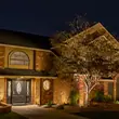 Landscape holiday lighting installation for a home