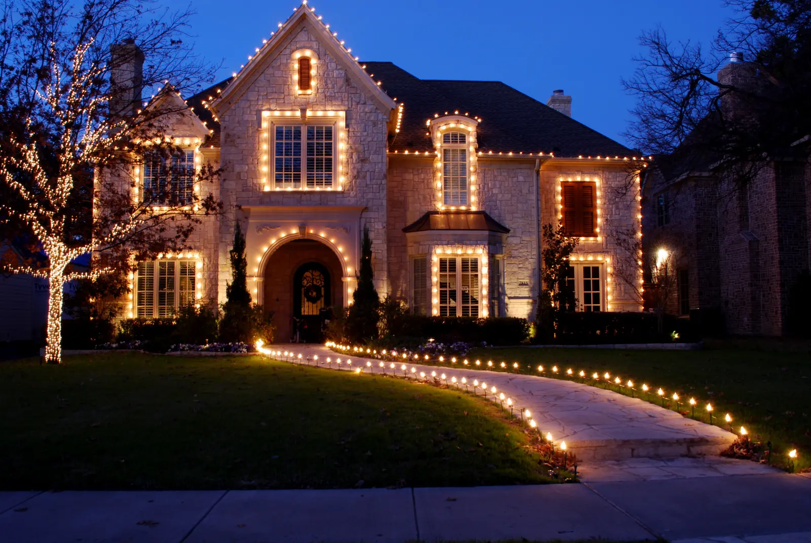 Luxury home with warm architectural roofline lighting after dark