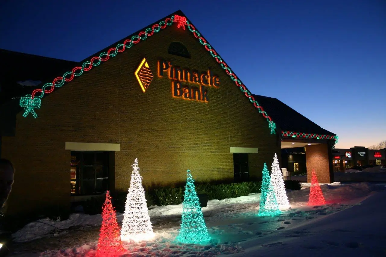 Commercial holiday lighting installation with colorful cone trees