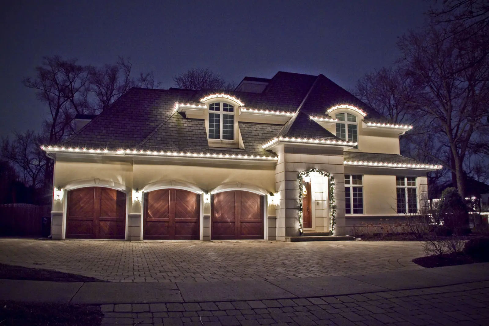 Residential Holiday Lighting outlining a home and attached garage